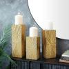 imageCosmoLiving by Cosmopolitan Wood Geometric Carved Pillar Candle Holder Set of 3 12quot 10quot 8quotH GoldGold