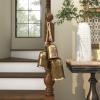 imageDeco 79 Gold Metal Tibetan Inspired Decorative Giant XL Cow Bells with Jute Hanging Rope Set of 3 10quot8quot6quotH  CylindricalLight Bronze