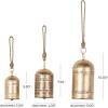 imageDeco 79 Gold Metal Tibetan Inspired Decorative Giant XL Cow Bells with Jute Hanging Rope Set of 3 10quot8quot6quotH  CylindricalLight Bronze