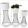 imageDeco 79 Metal Indoor Outdoor Planter Large Planter Pot with Black Hourglass Stands Set of 3 Planters 33quot 27quot 22quot H WhiteWhite