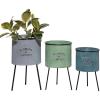 imageDeco 79 Metal Indoor Outdoor Planter Large Planter Pot with Flowers And Garden Text and Black Tripod Legs Set of 3 Planters 20quot 18quot 16quotH Multi Colored