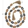 image:imageDeco 79 Mango Wood Handmade Round Double Layered Long Carved Garland with Tassel with Black and Cream Accents 80 x 2 x 2 Brown